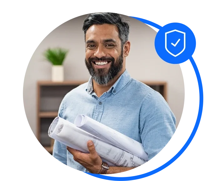 Male architect holding paper plans